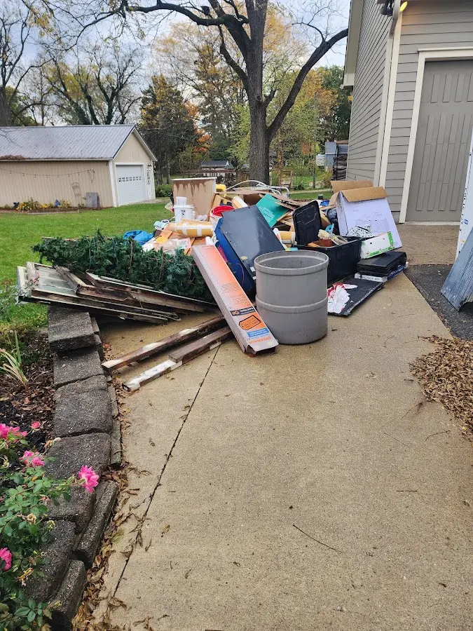 Dumpster being loaded with debris for 10 Yard Dumpster Rental in McGehee